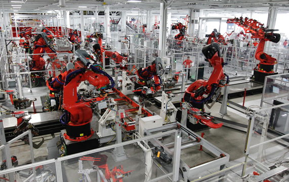 Industrial manufacturing floor filled with red robotic arms, each systematically positioned for metal 3D printing tasks.