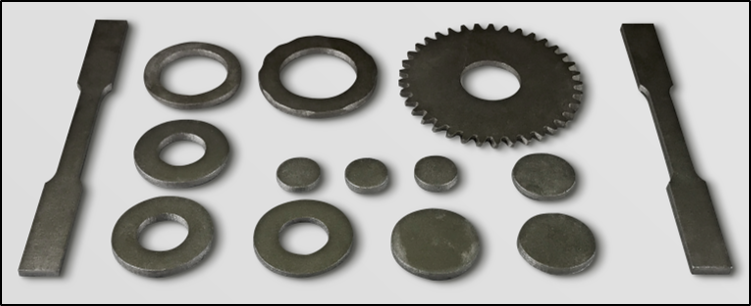 Assorted 3D printed metal parts including washers, gears, and flat bars arranged on a white background.