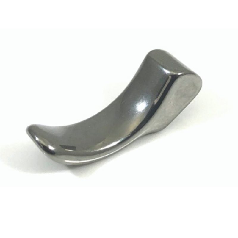 A shiny, curved, metallic object with a smooth surface, resembling a small ergonomic tool, placed on a plain white background.