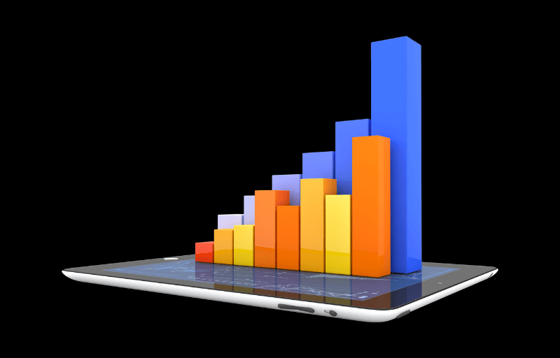 A tablet displays a colorful 3D bar chart with multiple vertical bars in different colors, illustrating data growth.
