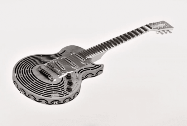 A black and white image of a unique, intricately designed resonator guitar with a spiral pattern on its body, created using a metal 3D printing service.