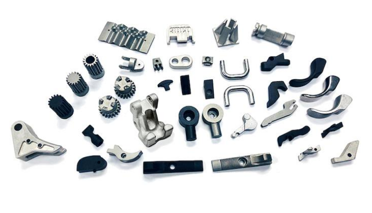 Assorted metal machine parts and components spread out on a white background.