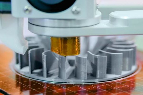 Close-up of a semiconductor wafer under examination by a precision inspection machine in a laboratory setting.