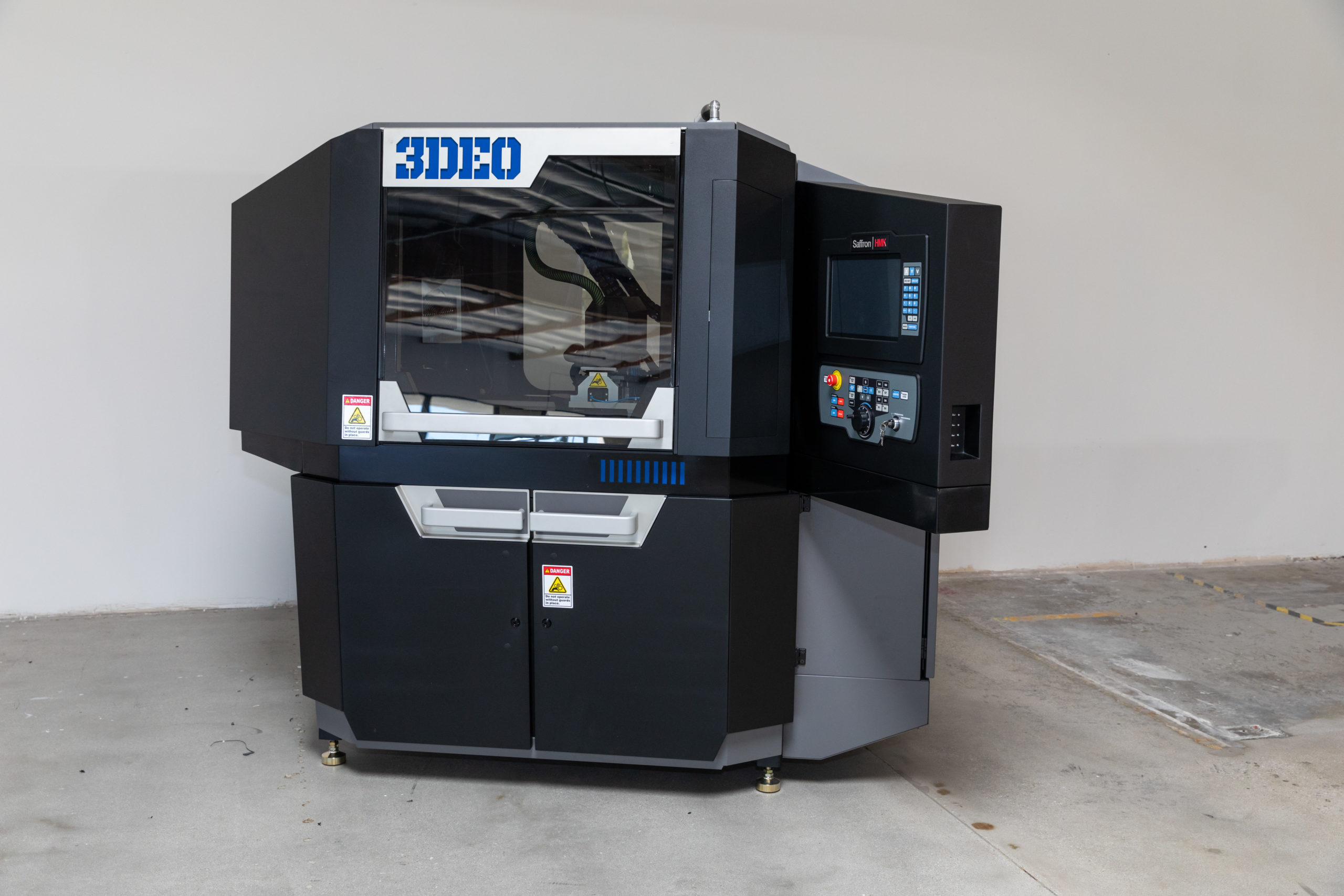 A 3deo metal 3d printer inside a clean industrial setting, featuring a prominent display panel and sleek black and blue design.