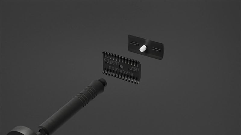 A black grooming tool with a detachable comb and bracket, crafted with precision using 3D metal printing, sits elegantly against a dark background.