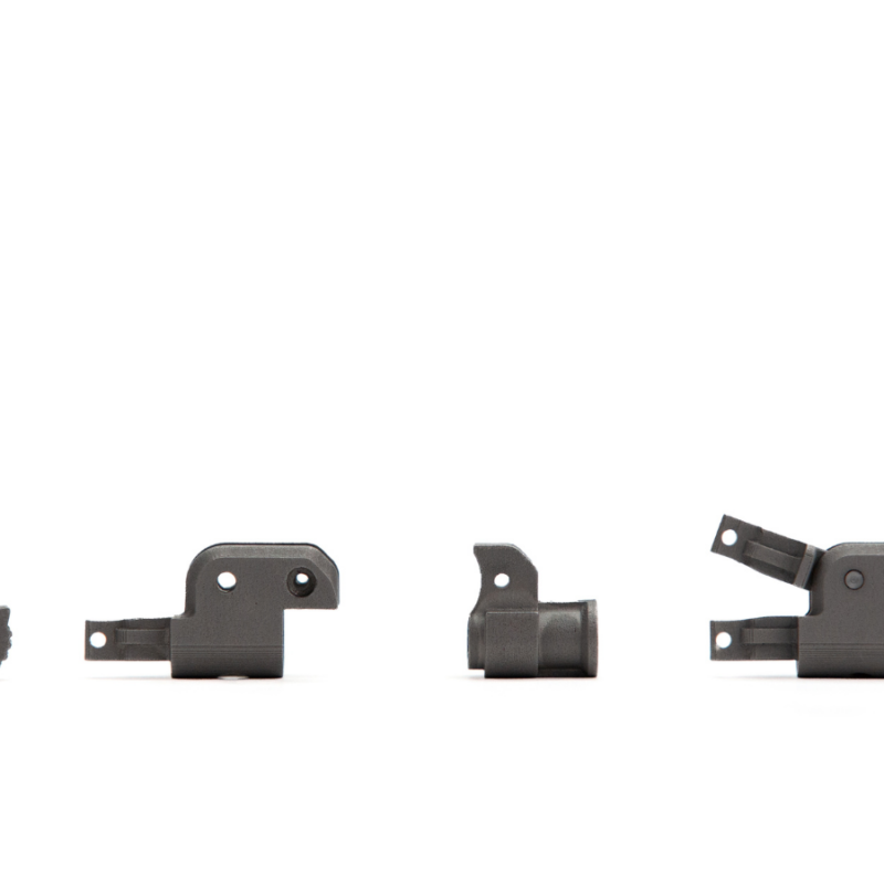 Four black metal components, varying in size and shape, are aligned horizontally against a white background, reflecting quality craftsmanship to aid assembly simplification.